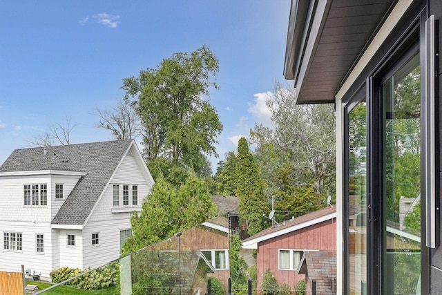 exterior space featuring a shingled roof