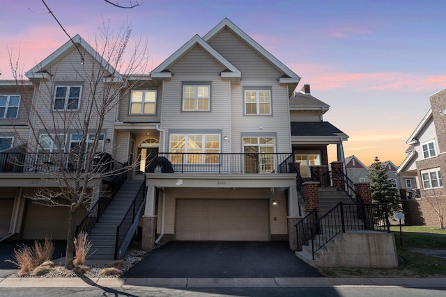 view of front of home with a garage, stairs, and driveway