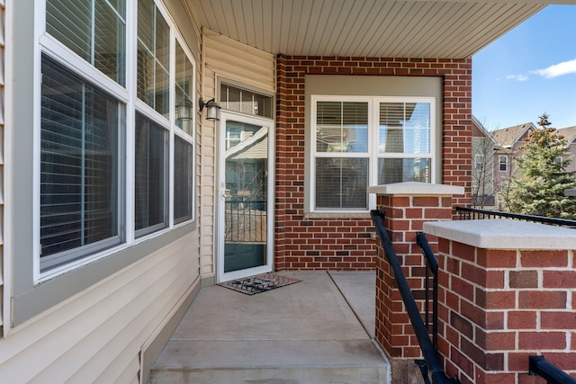 entrance to property with brick siding and covered porch