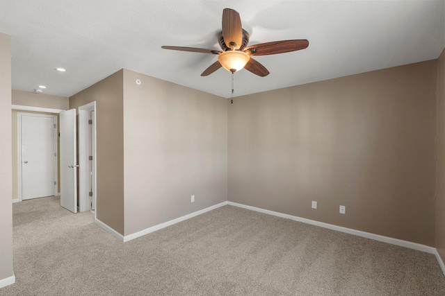 empty room featuring baseboards, light colored carpet, recessed lighting, and ceiling fan