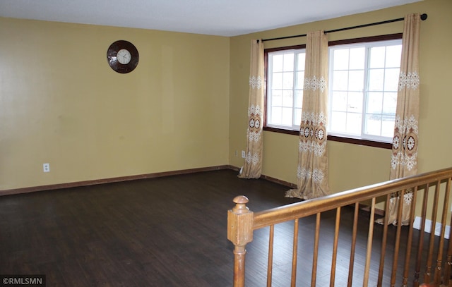 spare room featuring dark hardwood / wood-style floors