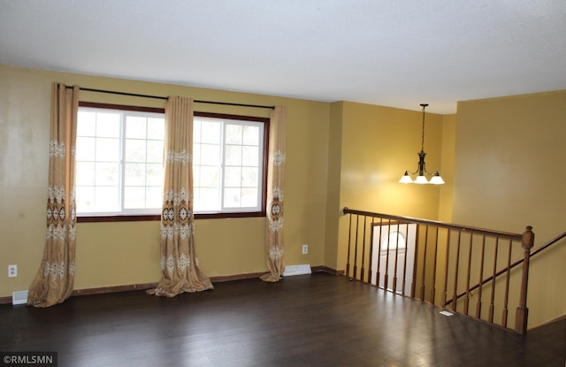 spare room with dark hardwood / wood-style flooring