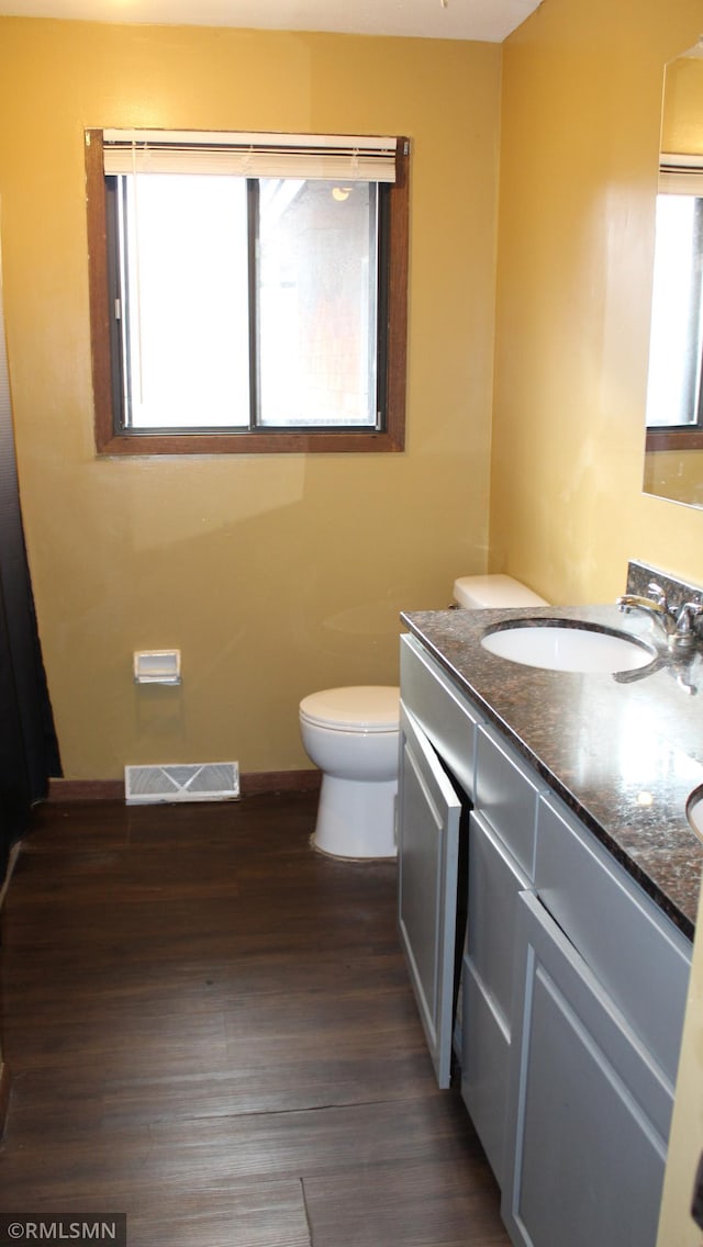 bathroom featuring hardwood / wood-style floors, vanity, and toilet