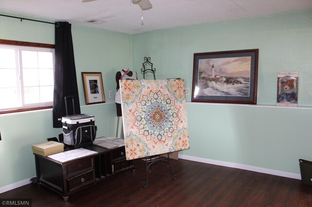 home office with wood-type flooring and ceiling fan