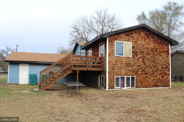 back of property featuring a yard and a wooden deck