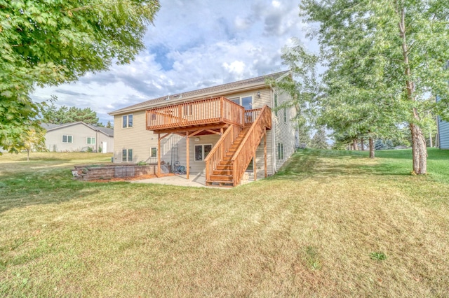 rear view of property with a lawn, a wooden deck, and a patio