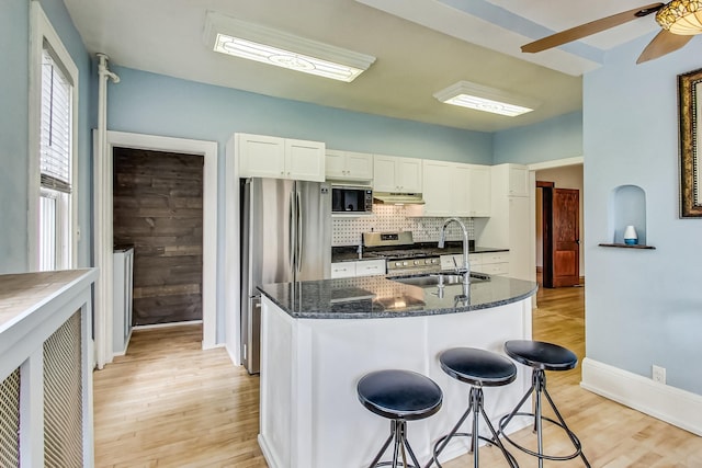 kitchen featuring sink, white cabinetry, light hardwood / wood-style flooring, appliances with stainless steel finishes, and ceiling fan