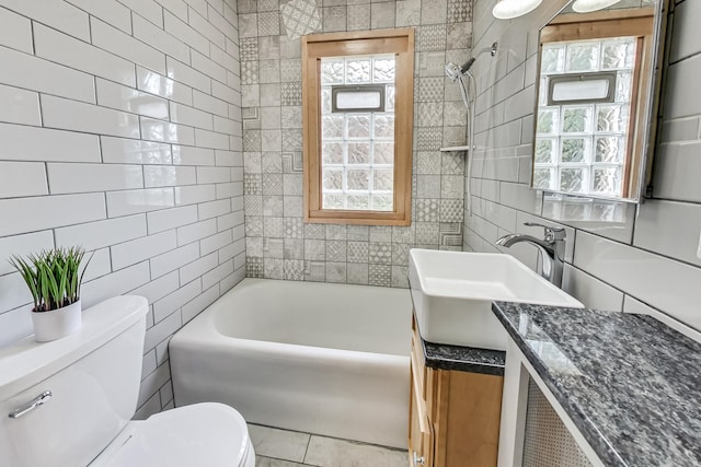 full bathroom featuring tile walls, shower / bath combination, vanity, and toilet