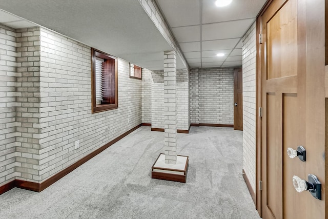 basement with light carpet and brick wall