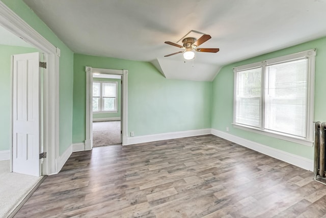 unfurnished room with wood-type flooring, vaulted ceiling, and ceiling fan