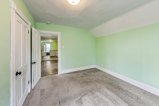 additional living space with lofted ceiling and carpet