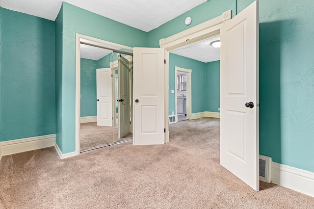 unfurnished bedroom featuring a closet and carpet flooring