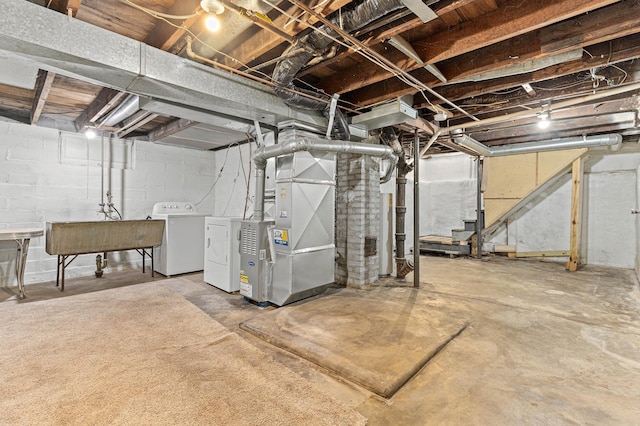 basement with heating unit and washer and dryer