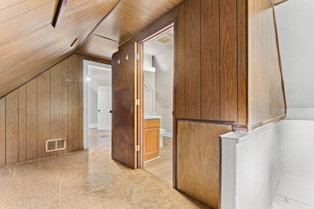 interior space featuring lofted ceiling, wood walls, light hardwood / wood-style floors, and wood ceiling