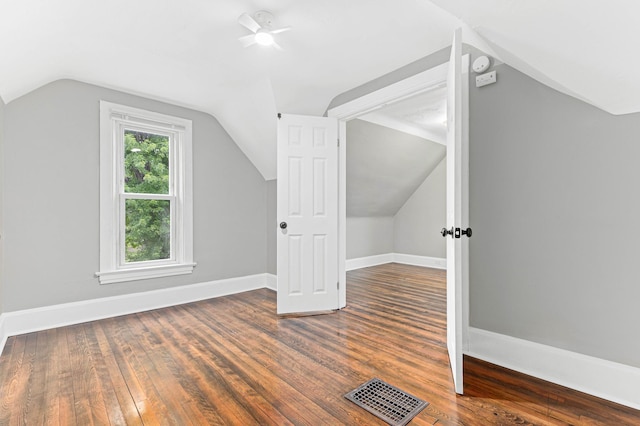 bonus room featuring vaulted ceiling, ceiling fan, and dark wood-type flooring