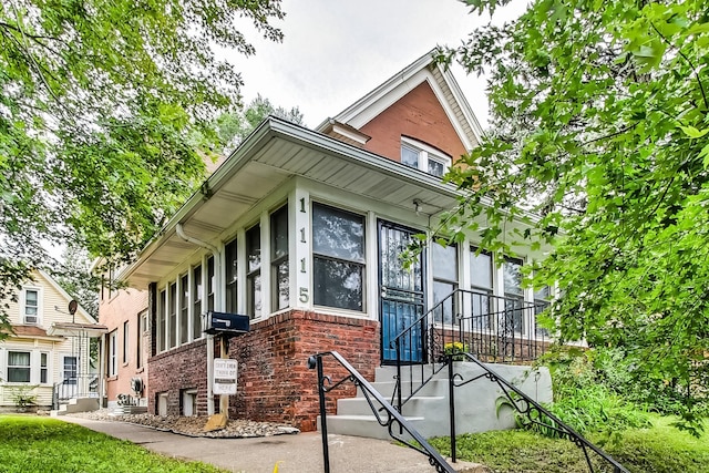 view of property exterior with entry steps and brick siding