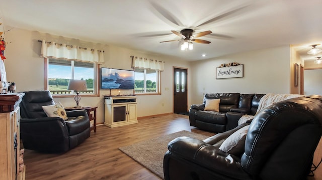 living room with ceiling fan and light wood-type flooring