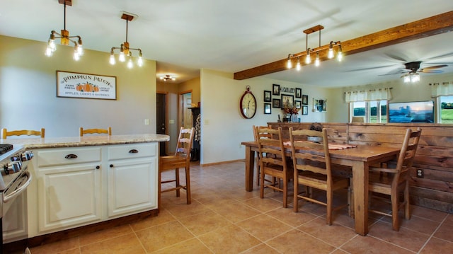 dining room featuring beam ceiling, light tile patterned floors, and ceiling fan