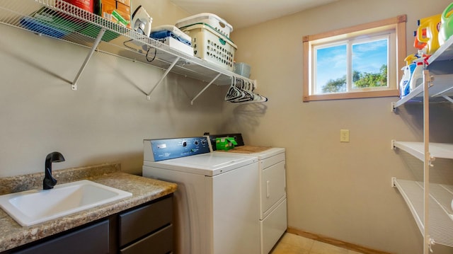 clothes washing area featuring washer and clothes dryer and sink