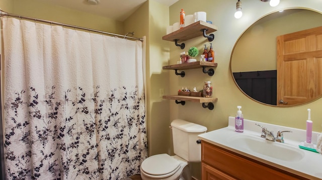 bathroom with toilet, vanity, and curtained shower