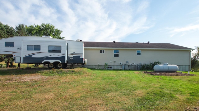 rear view of property featuring a yard