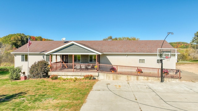 single story home with covered porch and a front yard