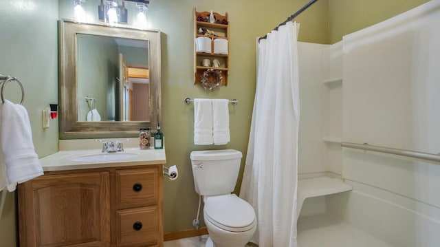 bathroom with vanity, toilet, and walk in shower