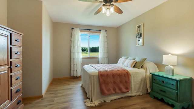 bedroom with ceiling fan and light hardwood / wood-style floors