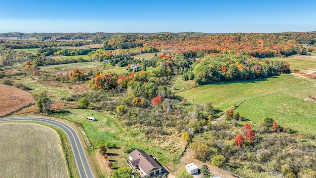 birds eye view of property with a rural view