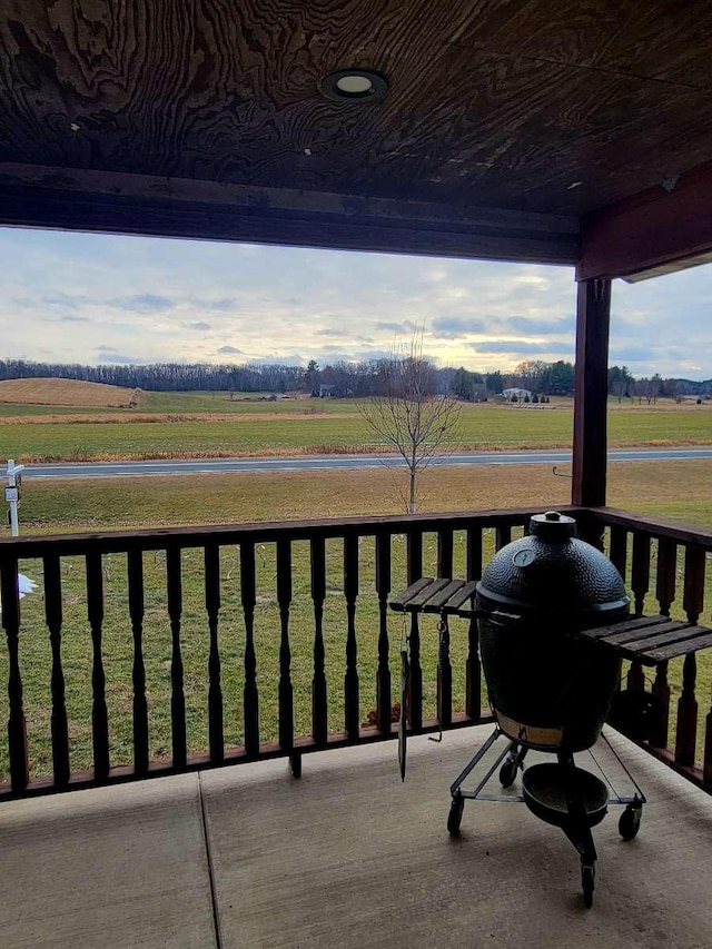 balcony with area for grilling and a rural view