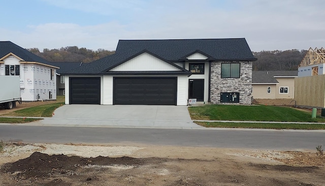 view of front of home featuring a garage and a front lawn