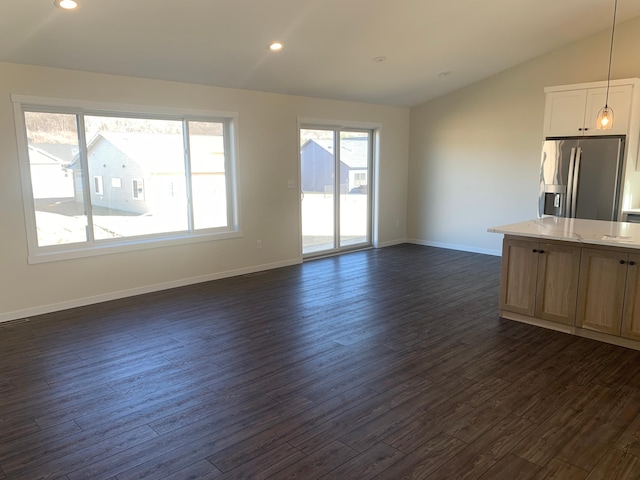 unfurnished living room with lofted ceiling and dark wood-type flooring