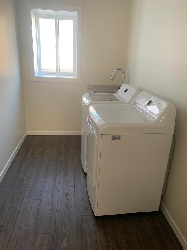 washroom with dark hardwood / wood-style flooring and washer and clothes dryer