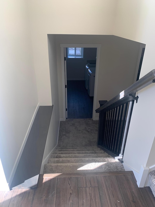 staircase with hardwood / wood-style flooring and washer and dryer