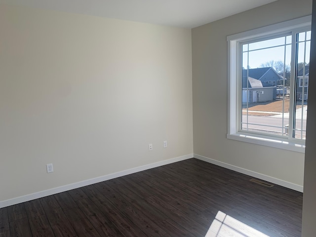 empty room with dark wood-type flooring