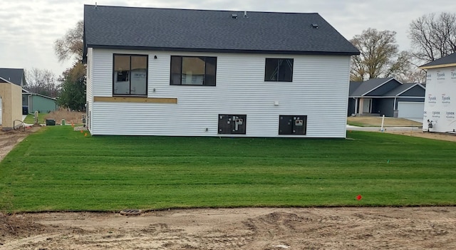 rear view of property with a yard