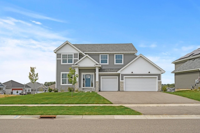 view of front facade featuring a front yard and a garage