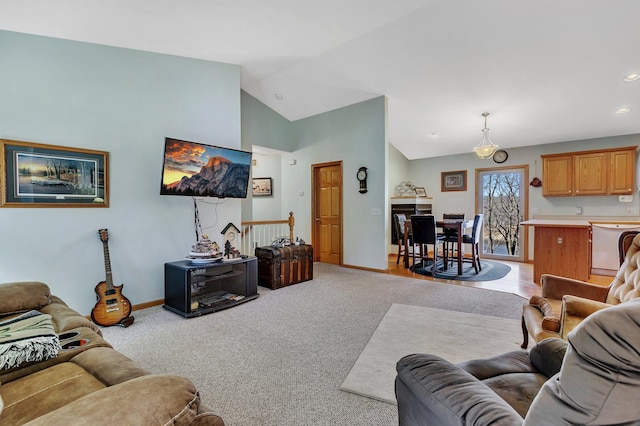 carpeted living room featuring vaulted ceiling