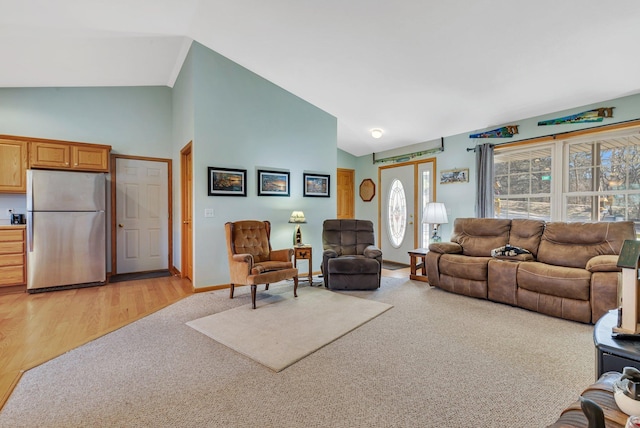 living room with lofted ceiling and light colored carpet