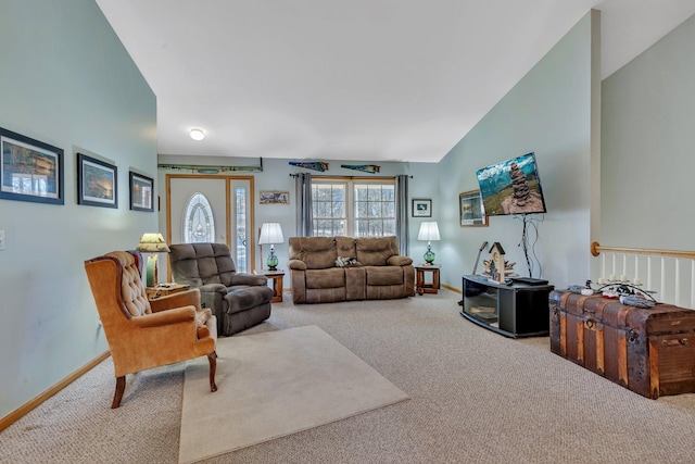 living room featuring carpet and vaulted ceiling