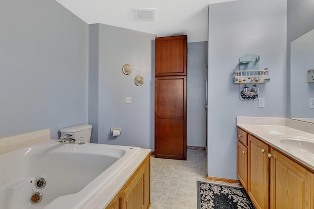 bathroom with toilet, vanity, and a tub