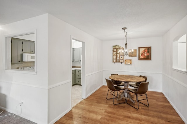 dining area featuring a chandelier and wood finished floors