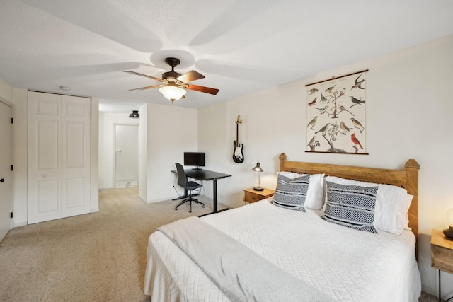 bedroom featuring light carpet and a ceiling fan