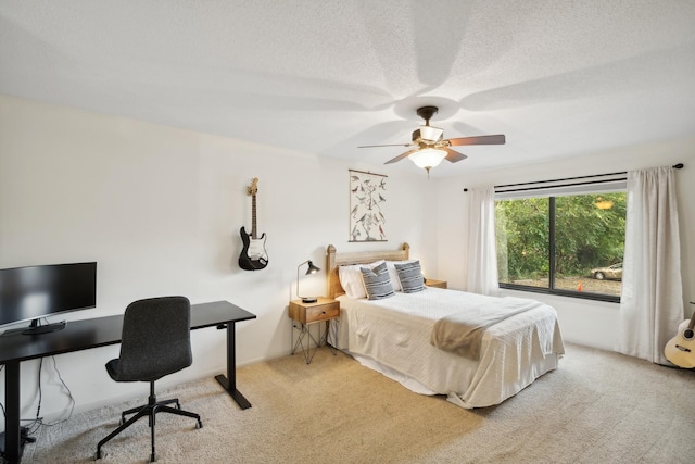 bedroom with light carpet, ceiling fan, and a textured ceiling