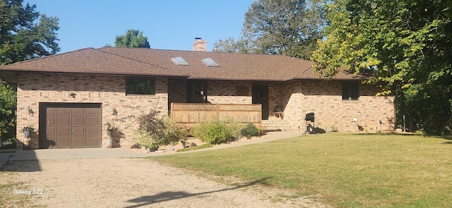 ranch-style home featuring a garage and a front lawn