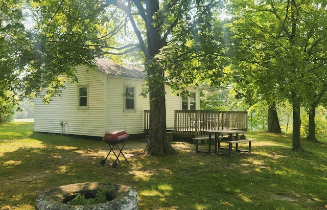 view of yard featuring an outdoor fire pit and a deck