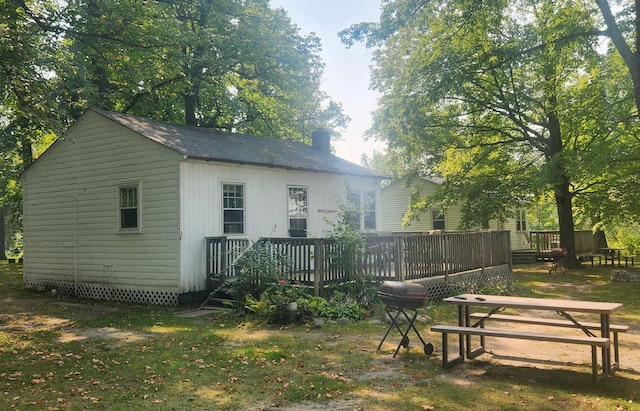 rear view of house with a wooden deck