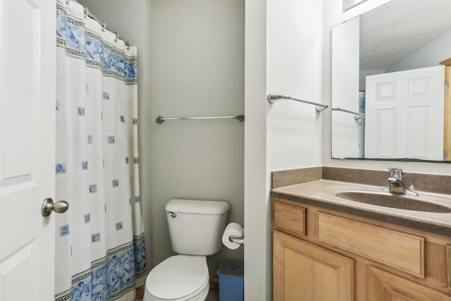 bathroom featuring vanity, curtained shower, a textured ceiling, and toilet