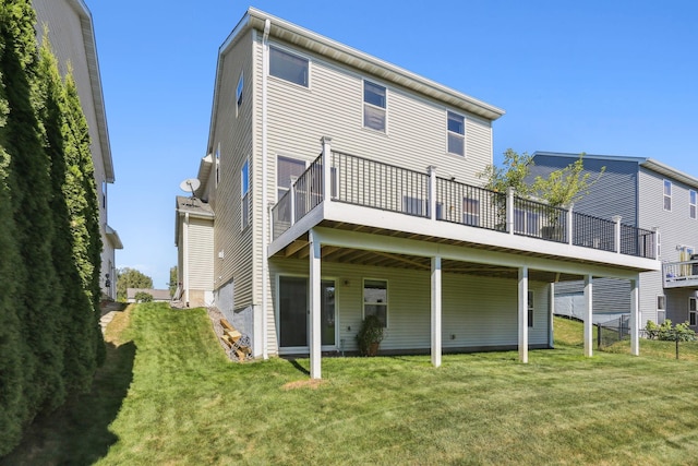 back of property with a lawn and a deck