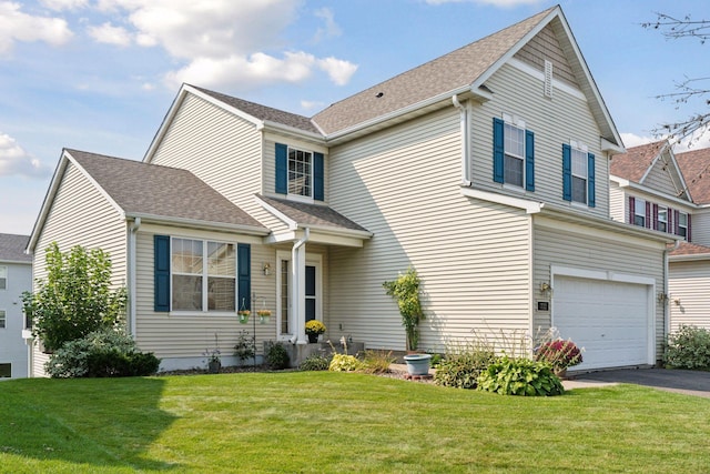 view of front of home featuring a garage and a front yard